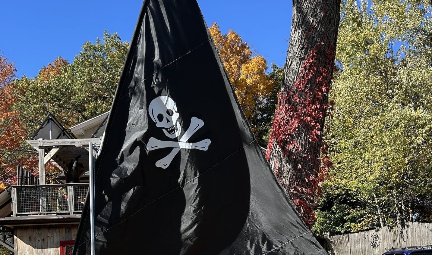 Skeleton crew sails across front lawn at 23 Pine Vale Rd. Waltham. Photo by Jim Luckett founder and owner of SailboatsToGo.com. This inflatable sailboat is one of his products.