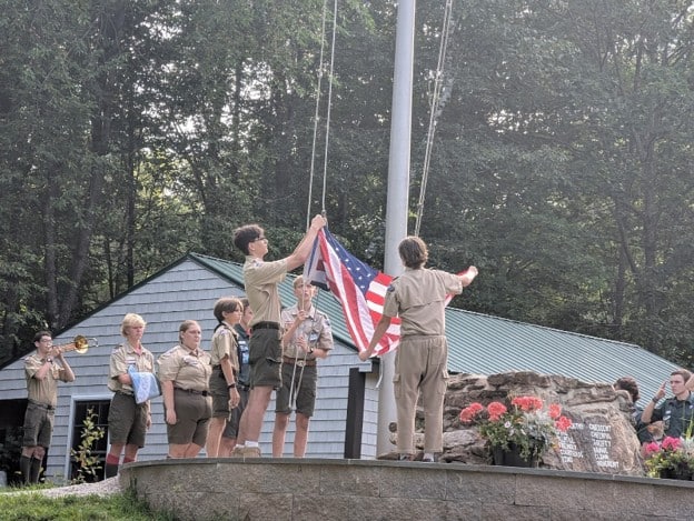 Waltham scouts raise flag at camp opening. Photo courtesy of Robert Logan.