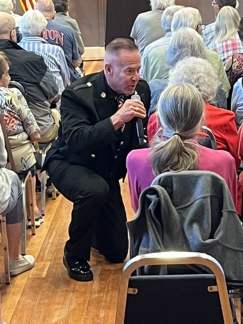 Sgt. Clark sings happy birthday to Waltham senior Rosanne Cormier. Photo by Steve Milmore.